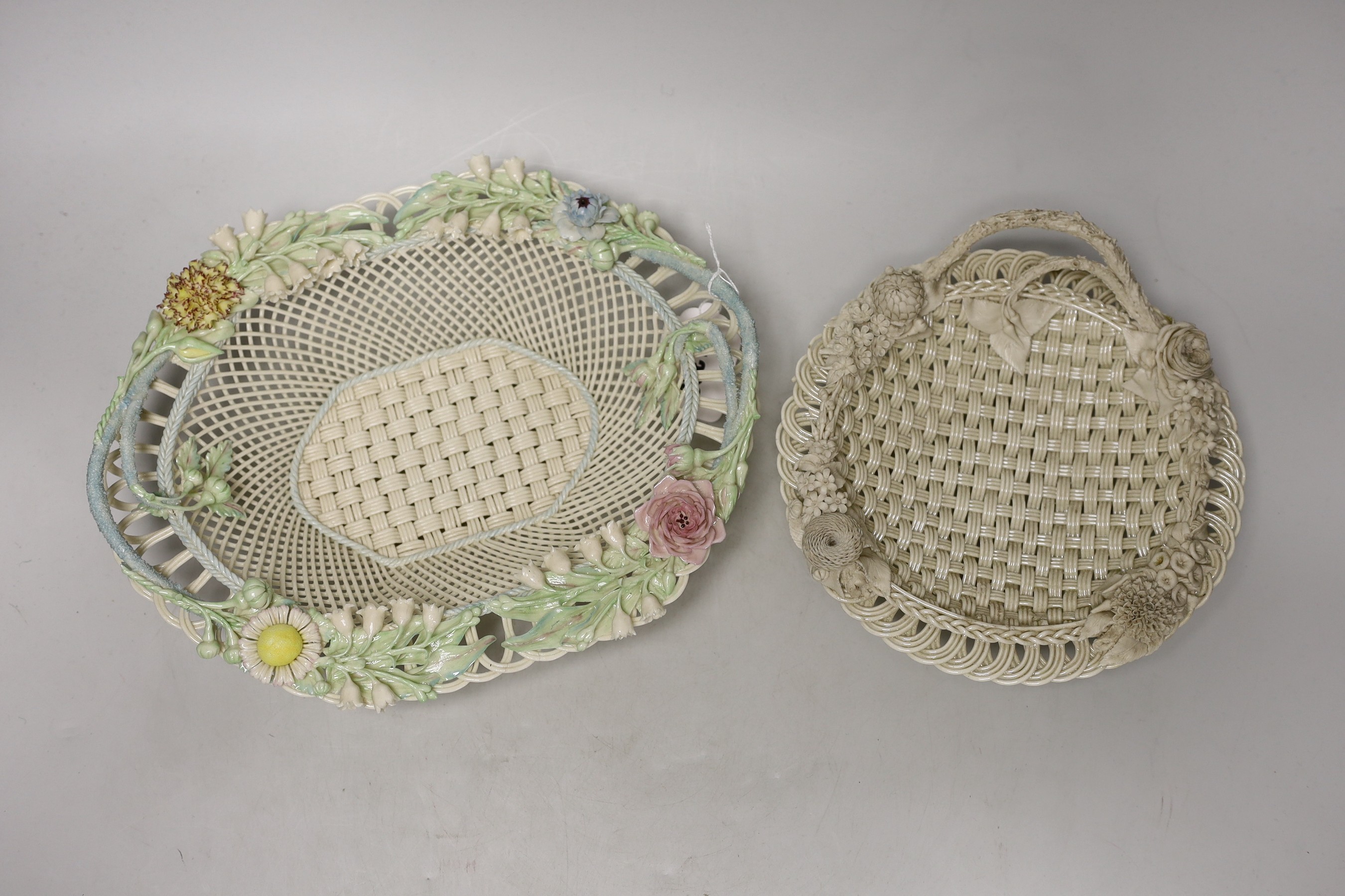 A Belleek coloured basket and similar smaller basket, large coloured basket 29cms wide